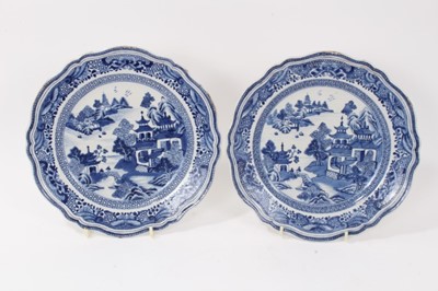 Lot 50 - Fine quality pair of antique 18th century Chinese blue and white porcelain plates, of scalloped form with moulded rims, painted with landscape scenes, 24cm diameter