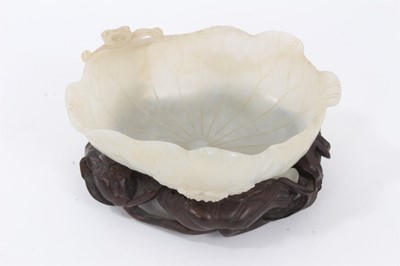 Lot 458 - 18th / 19th century pale celedon jade brush washer on a carved wooden stand