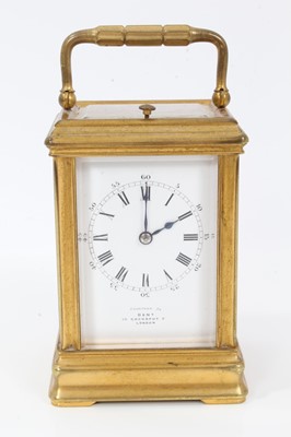 Lot 916 - Late Victorian repeating carriage clock retailed by Dent, 35 Cockspur Street, London, striking on gong  with enamel dial, gilt brass case of small proportions with strike/ silent lever to underside...