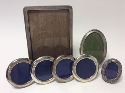 Lot 163 - George V silver photograph frame of rectangular form with rounded corners (Birmingham 1918), together with a George V silver photograph frame of oval form (Birmingham 1920)