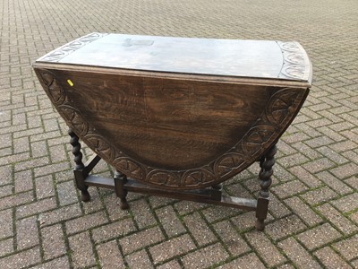 Lot 74 - Carved oak oval drop leaf table