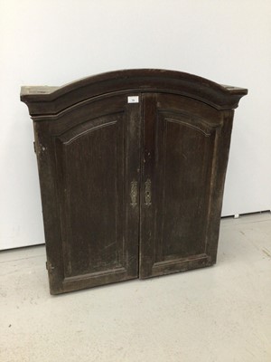 Lot 78 - 18th century French chestnut cabinet, arched form, e closed by pair of panelled doors, 81cm wide x 24cm deep x 106cm high