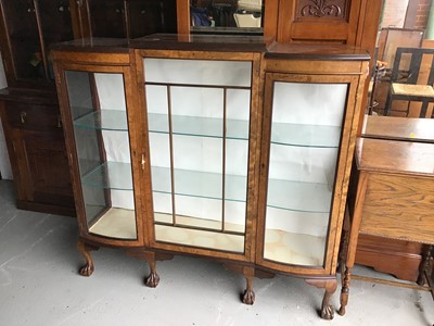 Lot 119 - 1930s walnut veneered display cabinet enclosed by three glazed doors with bowed glass panels on cabriole legs with ball and claw feet 134cm wide x 127cm high x 37cm deep