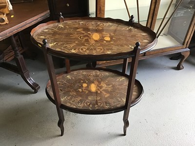 Lot 140 - Edwardian inlaid mahogany oval two-tier étagère with ivory, satinwood and boxwood inlaid decoration depicting cherubs, musical instruments and floral scroll, with original ivorine retailer's label...