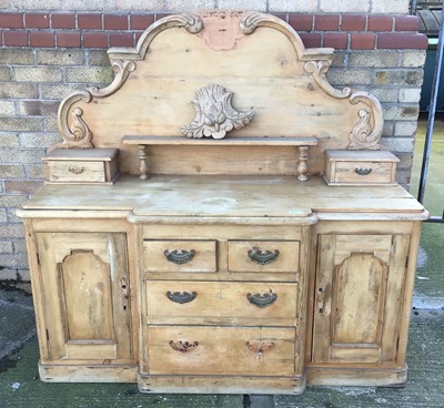 Lot 202 - Pine sideboard, the arched gallery back with carved cresting and short drawers, breakfront base with central drawers and flaking cupboards on plinth base, 148cm wide x 53cm deep x 144cm high