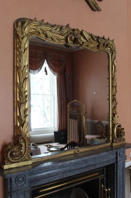 Lot 945 - Good quality 19th century gilt and gesso overmantel mirror with leaf mounded frame and scroll bracket supports, 117cm high x 144cm wide
