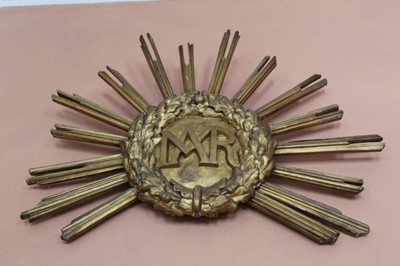Lot 919 - 19th century carved giltwood and gesso sunburst with central MAR initials, approximately 90cm wide