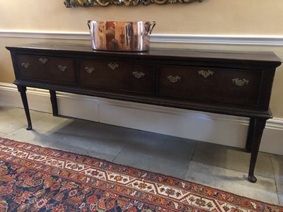 Lot 920 - 18th century oak dresser base with plant top above three deep drawers with brass swans neck handles, on tapered legs and pad feet, 213cm wide x 45.5cm deep x 83cm high