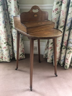 Lot 938 - Edwardian Sheraton revival inlaid mahogany needlework table with two lidded compare tins, bow front, on square taper legs terminating on castors, 51cm deep x 35cm wide x 88cm high
