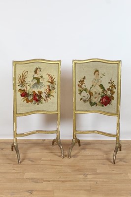 Lot 946 - Pair of 19th century gilt and gesso fire screens with shaped tops, each with tapestry panel depicting ladies with flowers, on reeded splayed legs, 109cm high x 53cm wide
