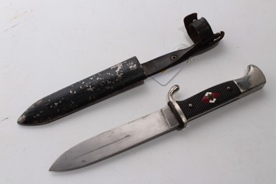 Lot 907 - Nazi Hitler Youth knife / dagger with chequered plastic grip, set with enamel swastika badge, plated mounts, etched blade marked RZM M7/80 39 in black painted scabbard with integral frog