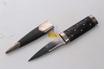 Lot 923 - Scottish Skean dhu dagger with silver mounts, ebony hilt with studded decoration, tapered, blade, in sheath, stamped Sterling Silver 925, 20.5cm overall