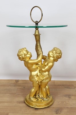 Lot 788 - Occasional table with circular glass top on gesso putti supports