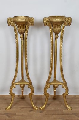 Lot 764 - Pair of Robert Adams style Neoclassical giltwood and gesso torcheres with rams head terminals