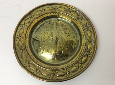Lot 443 - 17th century German brass alms dish, with Adam and Eve embossed convex roundel and broad geometric border, 35cm diameter 
Provenance: Estate of the Late Jane Sumner