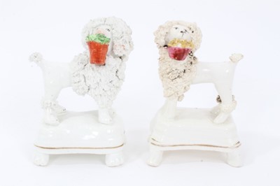 Lot 159 - Two Staffordshire porcelain poodles with baskets, c.1840, highlighted in enamels and gilt, 9.5cm height