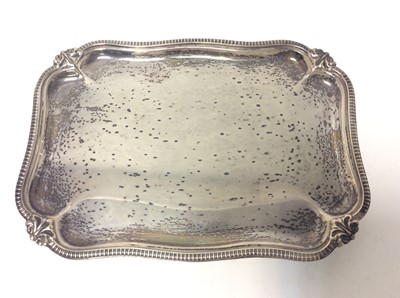 Lot 183 - George V silver waiter of rectangular form with gadrooned and scroll borders, raised on four scroll feet, (Sheffield 1926), maker Harrison Brothers & Howson, all at approximately 13oz, 20cm in leng...