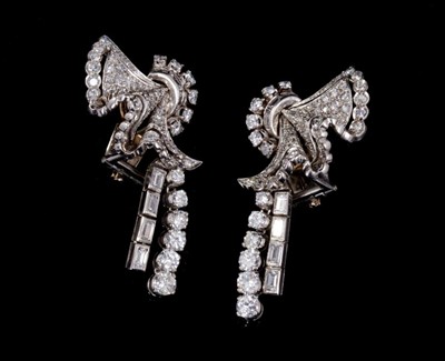 Lot 241 - Pair of Art Deco diamond earrings, each with a stylized fan with pavé set diamonds, single-cut, brilliant cut and baguette cut diamonds, suspending an articulated pendant drop of graduated baguette...