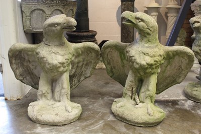 Lot 836 - Pair of composition concrete statues of eagles, on circular plinth, 85cm high