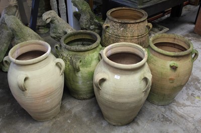 Lot 858 - A set of four substantial terracotta garden urns together with another larger