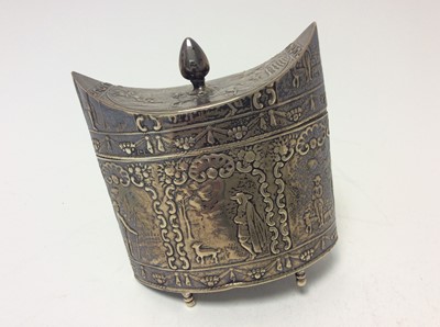 Lot 192 - Dutch silver tea caddy of navette form with embossed figural decoration and hinged cover, raised on four feet (one detached but present), import marks for London 1900, and marked for Isaac Manheim...