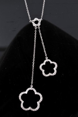 Lot 312 - Diamond negligee necklace with three open stylized flowers set with single cut diamonds in 9ct white gold setting on trace chain links. Length of pendant drop approximately 80mm, length of necklace...