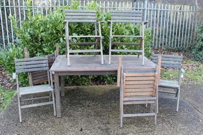 Lot 867 - Teak garden table together with set of six folding teak garden chairs