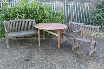 Lot 871 - Circular teak garden table, together with set of three garden armchairs, another pair and three garden benches