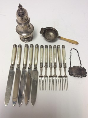 Lot 230 - George V silver sugar caster of baluster form, with pierced slip in cover, on circular foot, (London 1927), together with a silver tea strainer, (Birmingham 1936), silver decanter label engraved 'P...