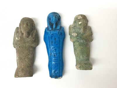 Lot 508 - Three ancient Egyptian ushabti, including a terracotta example with traces of hieroglyphs to the back, one in green faience and one in blue faience, the largest 9.5cm length