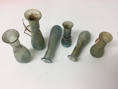 Lot 513 - Six small Roman glass tear bottles, including iridescent blue examples, the largest 6.5cm length
