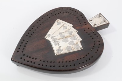 Lot 501 - Victorian silver and ebonised cribbage board, Birmingham 1900, maker W&Co, in the form of a spade with four silver cards to the centre, the base with covered compartment, raised on three feet 12.5c...