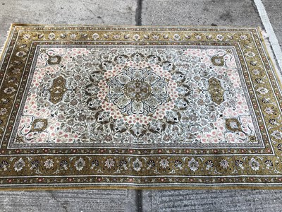 Lot 1013 - Kashan part rug silk, with cream ground and petalled medallion and concentric bird and foliate surround, in multiple bronze borders and tassel ends, approximately 220 x 310cm