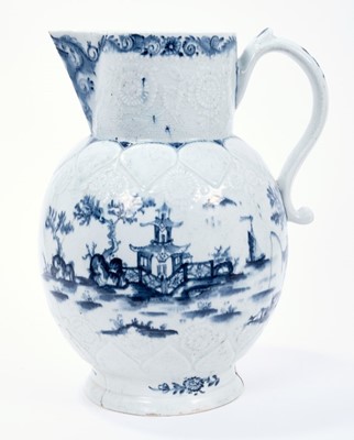 Lot 15 - Lowestoft jug, of large size, the neck moulded with flowers and leaves, the shoulder with lappets and flowers, painted in blue with a fisherman within an elaborate Chinese river scene, painter's nu...