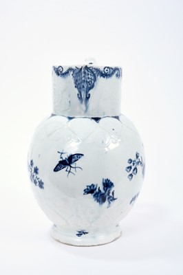 Lot 16 - Lowestoft jug, of large size, the neck moulded with flowers and leaves, lappets and florets around the shoulder and foot, painted in blue with flowering plants, painter's number 5 inside footrim, 2...