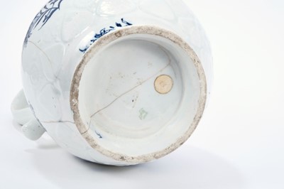 Lot 16 - Lowestoft jug, of large size, the neck moulded with flowers and leaves, lappets and florets around the shoulder and foot, painted in blue with flowering plants, painter's number 5 inside footrim, 2...