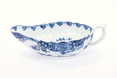 Lot 17 - Lowestoft sauceboat, of flat bottomed form with reeded sides, the interior printed in blue with a 'doughnut' tree, an elaborate painted border to the outside, 22cm long