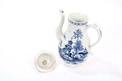 Lot 19 - Lowestoft coffee pot and cover, with a curved spout and button finial, painted in blue with a Chinese river scene within diaper borders, 23.5cm high