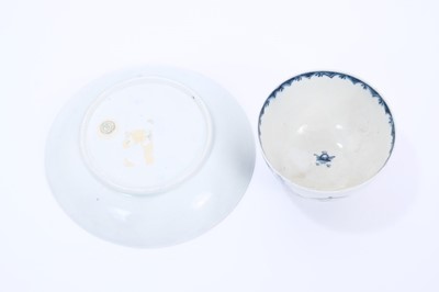 Lot 30 - Lowestoft tea bowl and saucer, painted in blue with Chinese river landscapes and a berry border, saucer 12.2cm diameter