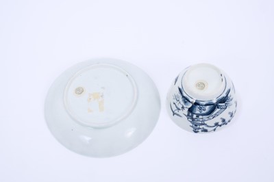 Lot 30 - Lowestoft tea bowl and saucer, painted in blue with Chinese river landscapes and a berry border, saucer 12.2cm diameter
