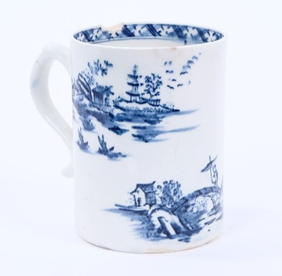 Lot 31 - Lowestoft mug, of small cylindrical form with a scrolled handle, printed in blue with a Chinese river landscape, a diaper border below the interior rim, 8.8cm high