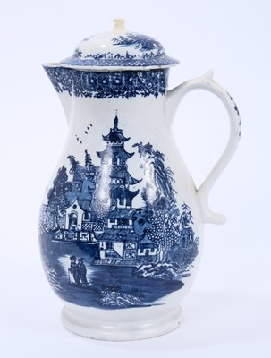Lot 32 - Lowestoft jug and cover, with a scrolled handle and a low domed cover, printed with a Chinese river cane below a printed cell border, 22.2cm high