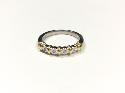 Lot 516 - Platinum diamond four stone ring with four brilliant cut diamonds in rub over setting interspaced with yellow gold spacers. Ring size O