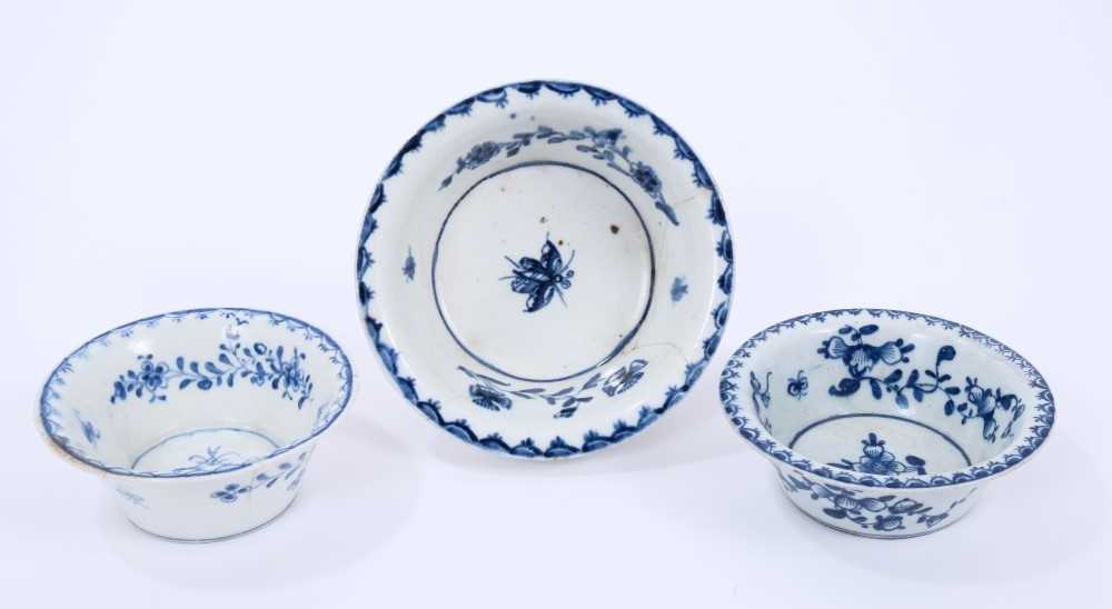 Lot 40 - Three Lowestoft patty pans, the first painted in blue with flowers within a berry border, painter's number 6 inside footrim, the other two painted with a moth within a berry border, between 9cm and...