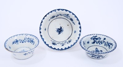 Lot 40 - Three Lowestoft patty pans, the first painted in blue with flowers within a berry border, painter's number 6 inside footrim, the other two painted with a moth within a berry border, between 9cm and...