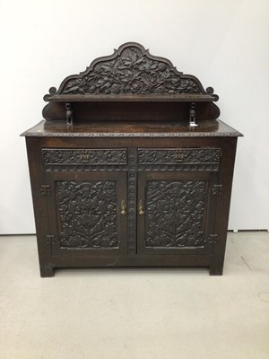 Lot 69 - Impressive 19th century Arts and Crafts carved oak Chiffonier, with arched gallery and shelf back raised on dragon supports, having two drawers and cupboards below on styles, allover relief carved...