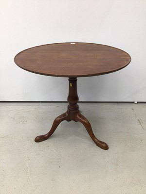 Lot 94 - George III mahogany wine table with circular dished top on birdcage mechanism,the baluster turned column with three hipped splayed legs terminating on pad feet.