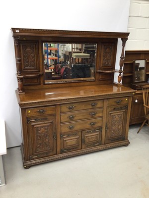 Lot 95 - Edwardian carved oak two height sideboard with mirrored back, Corinthian column supports, drawers and cupboards below.