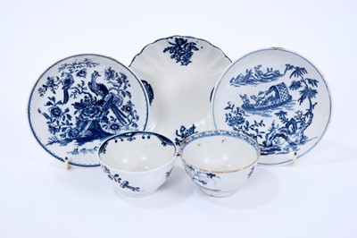Lot 46 - Lowestoft tea bowls and saucers, including a tea bowl painted in blue with trailing flowers, another printed with flowering plants within a fenced enclosure,  a fluted saucer printed with panels of...