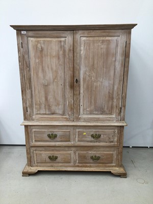 Lot 120 - Georgian style limed oak two height cupboard, with shelved upper section enclosed by pair of feielded panelled doors, the base with four short drawers on ogee bracket feet, 113cm wide x 57cm deep x...